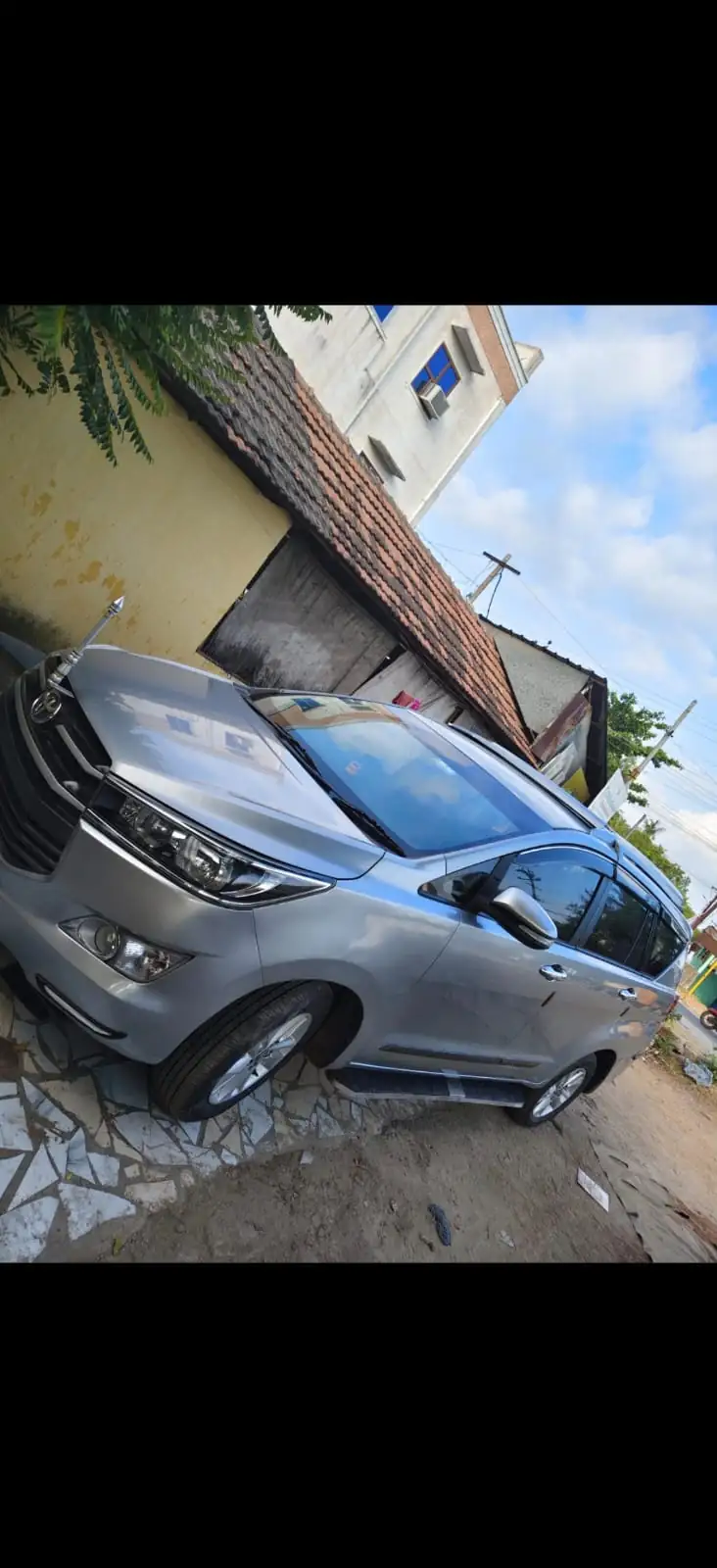 Grey Toyota Innova Crysta shown from the side